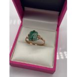 A Ladies 9ct gold ring set with a green agate style stone setting. [Size Q] [2 Grams]