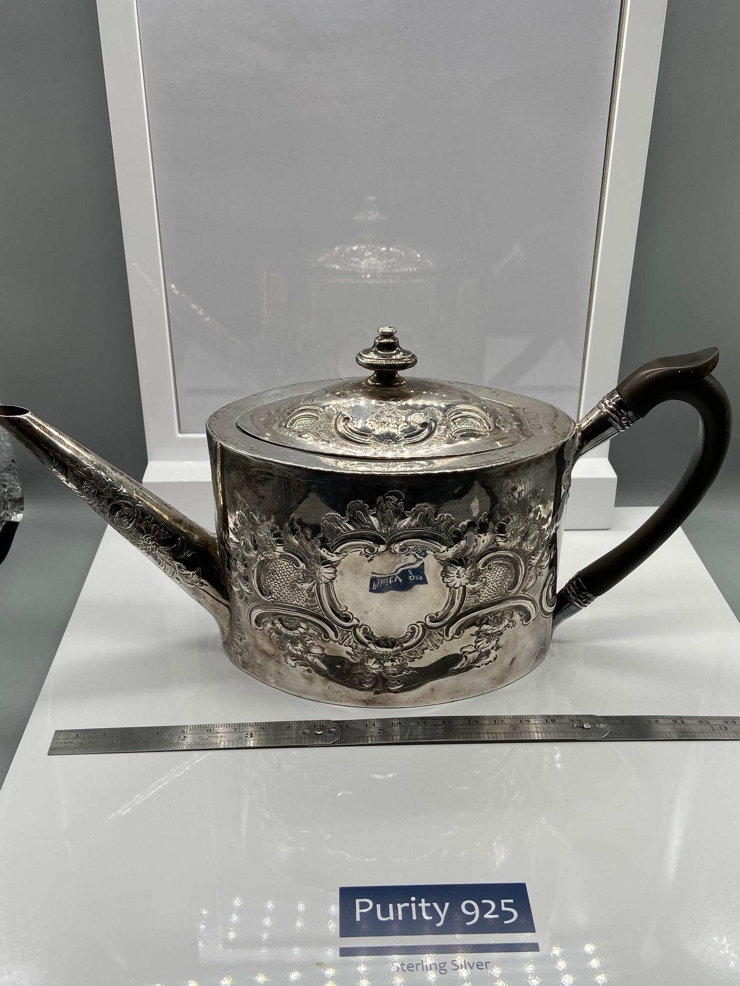 A Georgian London Silver ornate tea pot. Designed with a horn handle. Maker - George Burrows (I)