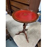 A Leather topped pedestal wine table.