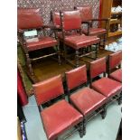 A Large antique dining table with pull out leaves. Together with 6 antique red leather and stud