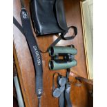 A Set of Swarovski binoculars with strap and carry case.