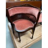 An Edwardian inlaid tub chair.