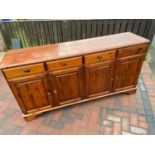 A Pine Ducal four drawer, four door sideboard.