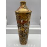 A Japanese Satsuma hand painted vase. Designed with various figures and gilt trims. Signed to the
