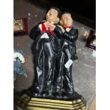 A Lot of various Laurel and Hardy collectables which includes Cast metal door stop, two silver