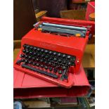 A Vintage Olivetti Valentine Red portable type writer.