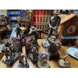 A Collection of John Wayne bronzed effect figures and busts produced by Bradford Exchange.