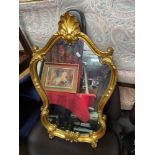 An ornate gilt framed mirror