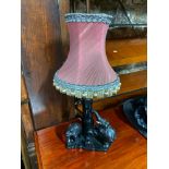 A Hand carved African elephant table lamp designed with an ornate shade.