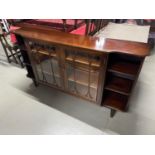 Antique style display cabinet designed with side book shelves.