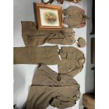 A WW2 Uniform which includes Long coat, dress jacket, trousers and Hat showing R.E.M.E. Cap badges