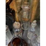 A Shelf of apothecary bottles and vessel glasses.