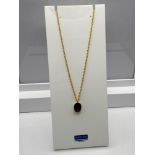 A Ladies 9ct gold necklace together with a 9ct gold and Smokey Quartz stone pendant. [Chain 45cm