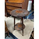 An Arts & Crafts two tier side table designed with carved top and turned leg supports. [59cm in