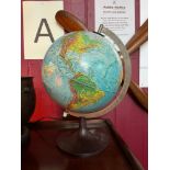 A vintage light up desk globe designed on a bakelite stand. [37cm in height]