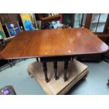 A Victorian mahogany drop end dining table designed with 6 turned leg supports.