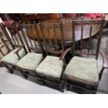 An Ercol elm wood dining table with leaf centre, Together with four Ercol high back dining chairs.