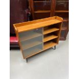 A Retro pedestal bookcase designed with two glass sliding doors