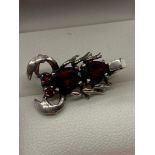 An unusual 925 silver lobster brooch set with Rubilite stones.