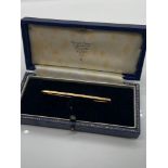 A 9ct gold bar brooch with a fitted box. [2 grams]