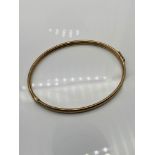 A 9ct gold bangle. [7x6cm][5 grams]