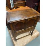 Antique oak pedestal unit designed with lift top, two doors and single under drawer