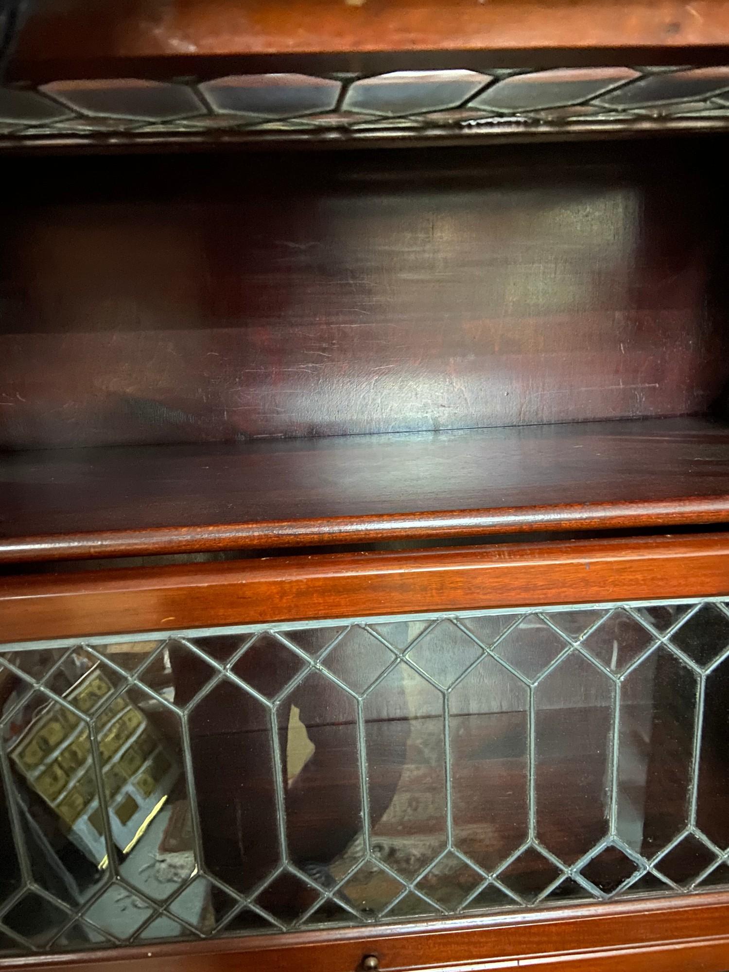 A Four section barristers bookcase designed with lead and glass lift up section doors. [155x87x35cm] - Image 3 of 4