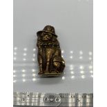A Brass vesta case in the form of a dog wearing a hat. [5.5cm in length]