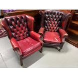 A Lot of two ox blood red chesterfield gull wing chairs. Cushions need attention.