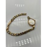 A Ladies 9ct gold Accurist Gold watch with 9ct gold bracelet. Bracelet link damaged. [12 grams]