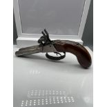 A 19th century double percussion pistol.