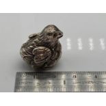 A Sterling silver figure of a Chick with glass eyes. [2cm in length]
