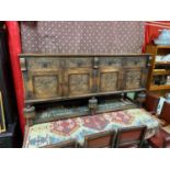 A Large antique carved sideboard. Detailing English rose panelled doors and drawer fronts. Showing