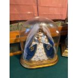 Antique domed glass display, showing a religious/ Queen style figure. Glass is damaged.