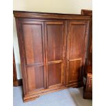 A Large Solid pine triple wardrobe with fitted drawer interior. Comes with key and is fully