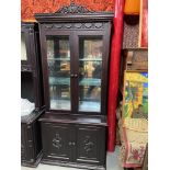 An Indian Rose Wood highly detailed display cabinet. Designed with two glass doors and glass