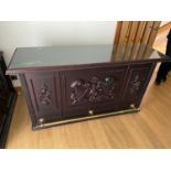 An Indian rose wood ornate panelled bar designed with a brass foot rest and glass bar top.