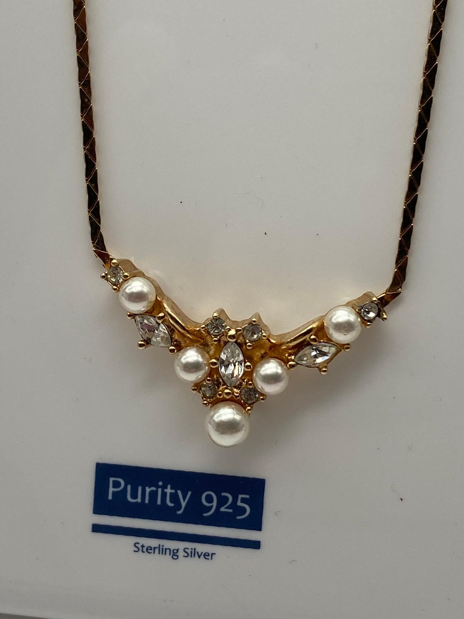 Christian Dior gold plated ladies necklace and ornate pendant designed with pearls and clear stones.