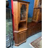 A Pine Ducal corner cabinet. Designed with glass top section door and shelf area.