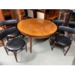A stylish Mid century teak G-Plan table with four G-plan circular style chairs.