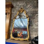 An ornate gilt framed mirror.