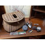 Antique fishing creel containing various fishing reels and lures