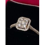A Lovely example of an 18ct gold diamond cluster ring of 60 points. [Ring size N1/2]