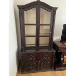 A Large Indian Rose wood display cabinet designed with ornate panel doors and glass top section