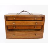 A portable oak collectors cabinet fitted with four drawers and slide.26.5(H) 41cm(W) 18.5(D)