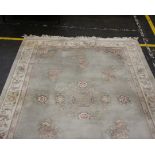A large Chinese machine woven wool rug, pink floral patterned on pale blue ground.300cm x 182cm