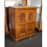 A c20th Oak cabinet of peg jointed construction. The carved panel door enclosing a fixed shelf.