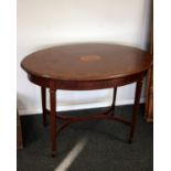 An Edwardian mahogany oval centre table the top marquetry inlaid with central fruitwood medallion