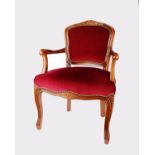 A modern shield back salon chair in the French style. Stained beech frame with burgundy velour