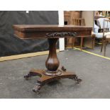 A Victorian mahogany flip top card table with circular inset top, single pedestal support to